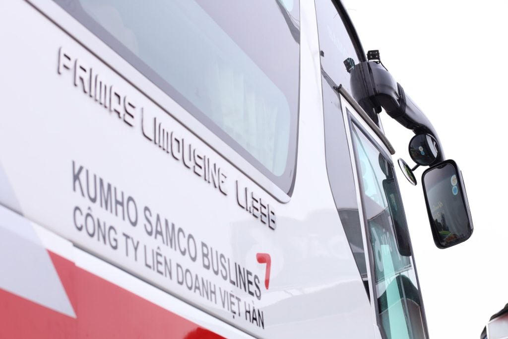 Xe khách Kumho Samco Buslines màu trắng đỏ với logo và gương chiếu hậu bên hông