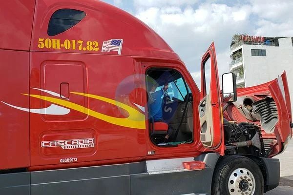 Đầu xe tải Freightliner Cascadia Evolution màu đỏ mở capo và cửa cabin